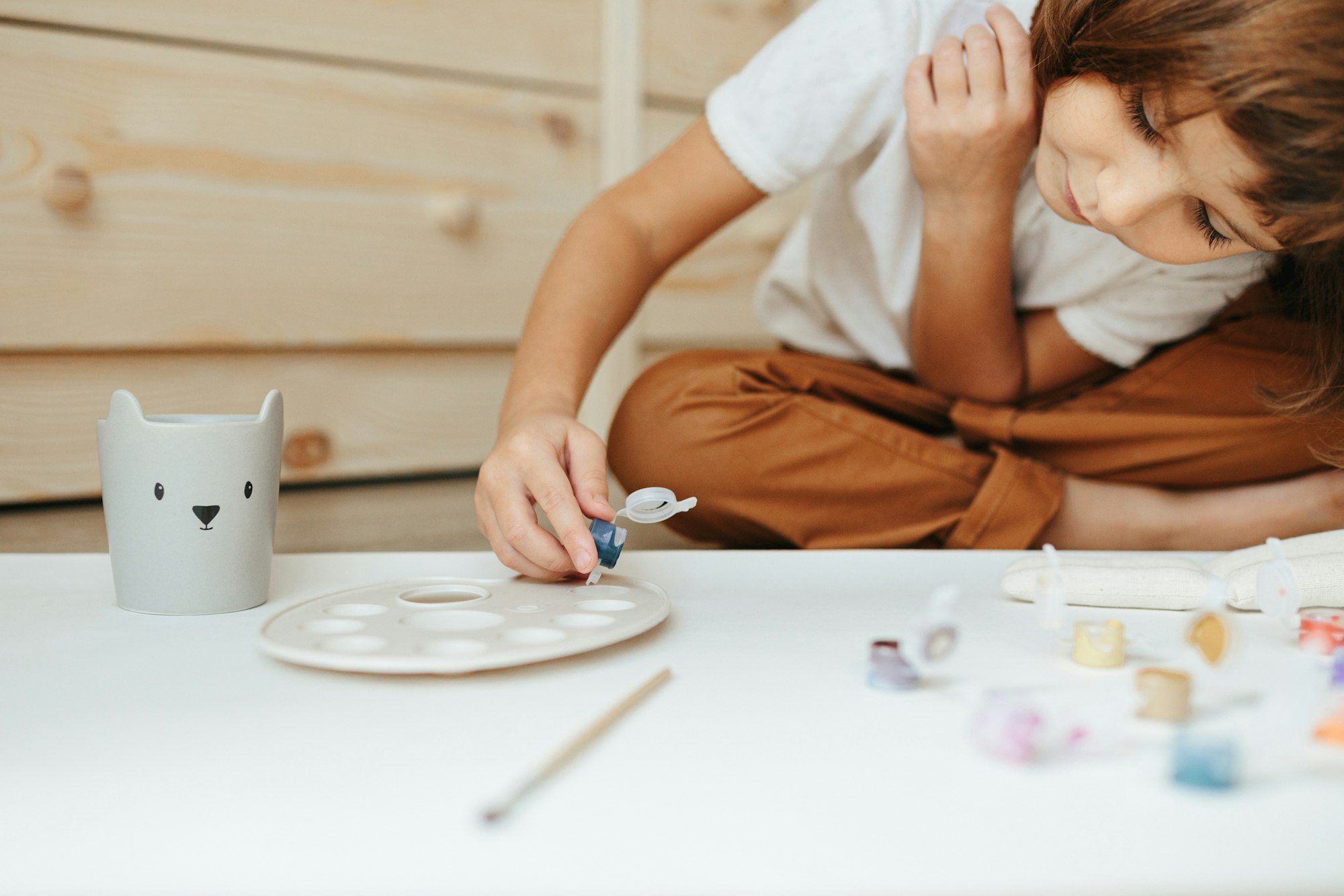 Child painting fabric toy. Art therapy, Expressive Therapy for children