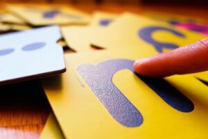 Montessori letter cards, finger swipe texture, enhances dyslexic children's learning.